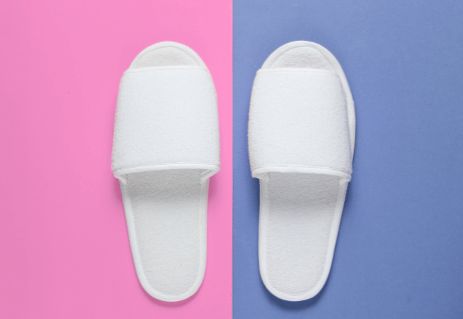 White hotel sleeping slippers on colored background.@Vladimir Sukhachev