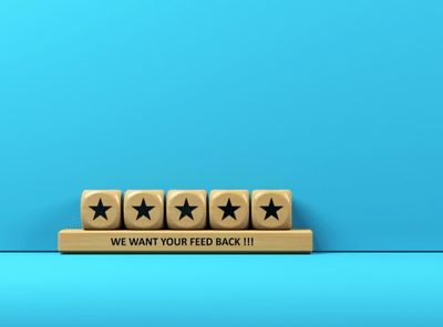Feedback concept Woodblocks with feedback text on blue-colored backgroundBaris-Ozer 400x296