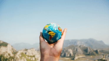 Hand-holding-a-globe-CanvaPro-370x208px