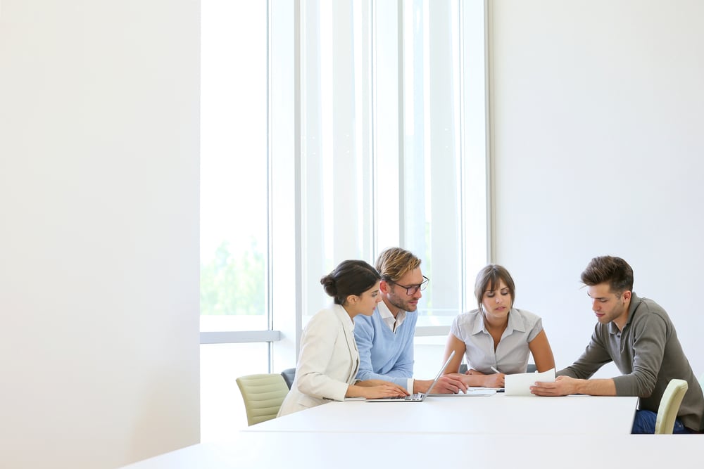 Business people meeting around table in modern space-1