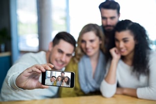 Group of friends taking a selfie in cafe