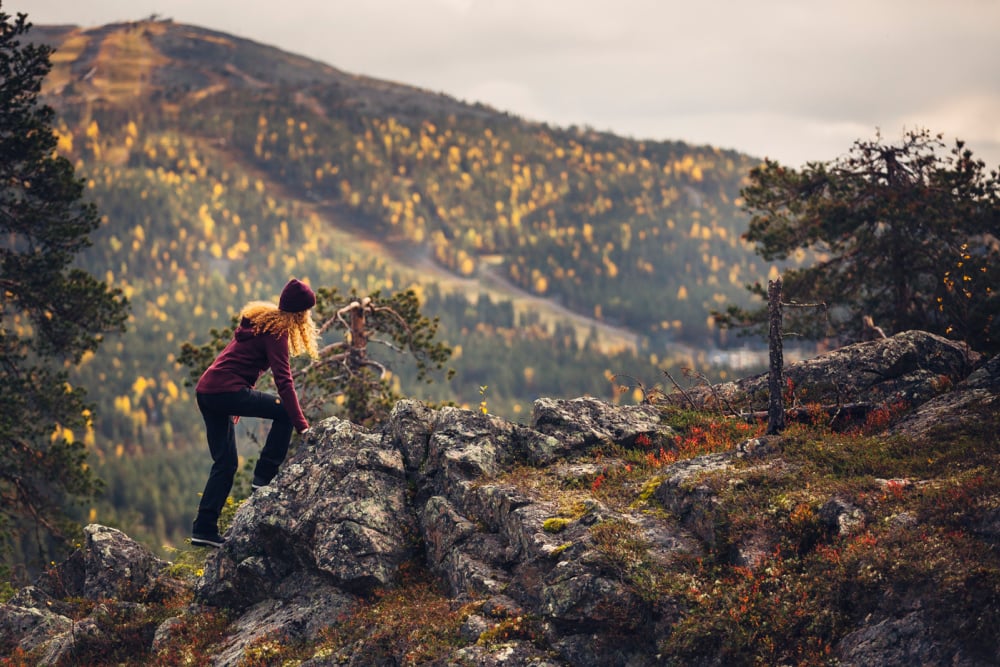 Girl climbing on top of cliff_Copyright_Visit Levi